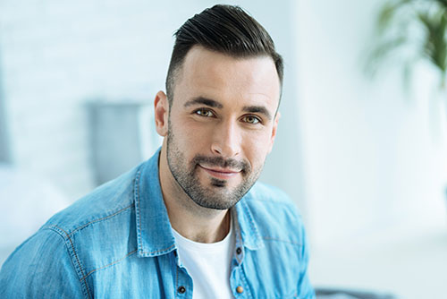 how much does drug rehab cost (1) A man smiles while he wonders how much does drug rehab cost